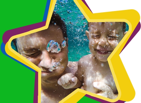 Testimonials teaser image: man and young boy smiling underwater swimming