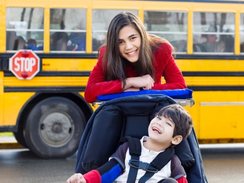 Funding Resources image: mother and son by school bus