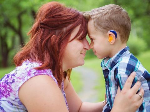 Support Groups image: mother and son with a hearing aid looking at each other